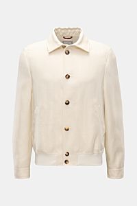 Brunello Cucinelli Blouson creme, Slim Fit, mit Umlegekragen, Sieben-Knopf-Leiste, schräge Taschen, Manschetten, elastischem Saum, leichte Webstruktur, Vorderansicht.