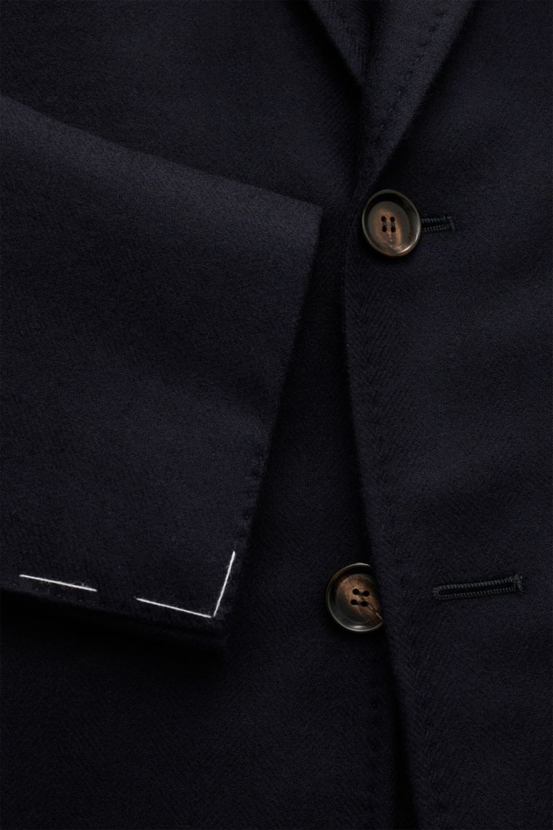 Close-up front view of the Stile Latino Smart-casual jacket 'Vincenzo' navy, showing wool with cashmere content, very soft feel, tonal herringbone, slim fit, fitted three-button style, step lapel, classic breast pocket, patch hip pockets, unfinished sleev