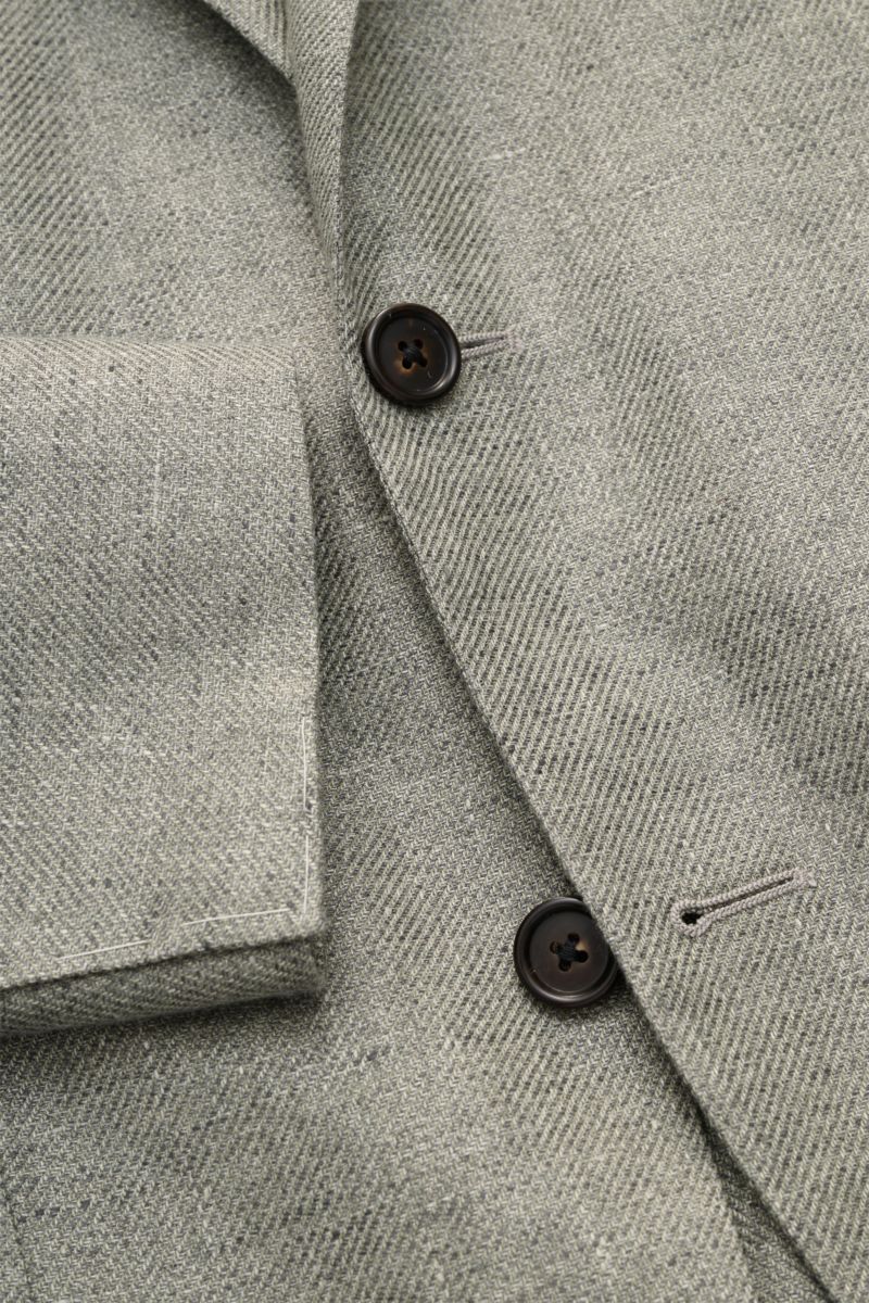 Close-up front view of Corneliani Smart-casual jacket sage mottled in lyocell and linen with dark buttons and step lapel.

Description: 
Superlative style from CORNELIANI: in a optimal fit made with Italian expertise, this smart-casual jacket in lightw