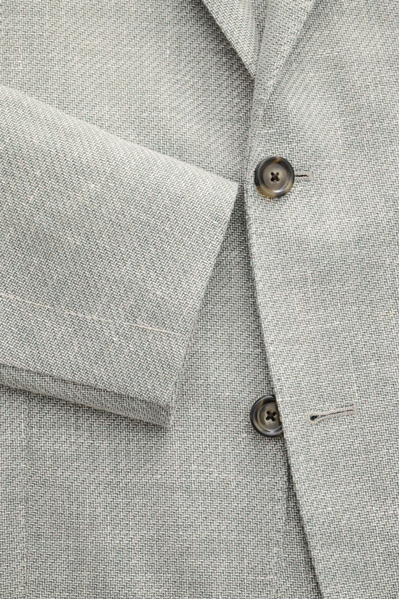 Nahaufnahme des Lardini Sakko salbei/offwhite meliert aus Schurwolle-Leinen-Mix, Fokus auf Ärmel und Knöpfe, seitliche Perspektive.