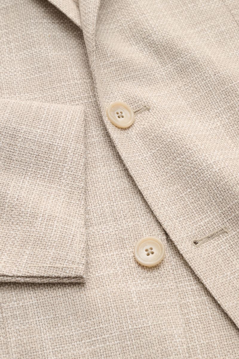 Close-up front view of the Tagliatore Smart-casual jacket 'Monte Carlo' beige mottled showing textured fabric, buttons, and patch pocket. The unconstructed finish in a fine blend of fabrics refined by effect yarn for a relaxed weave makes the smart-cas