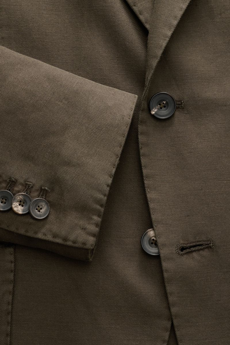 Close-up front and sleeve view of the Santaniello Smart-casual jacket dark brown showing buttons and fabric texture.

Modern tailoring for the transitional period: This smart-casual jacket by SANTANIELLO enhances numerous spring looks with its relaxed 