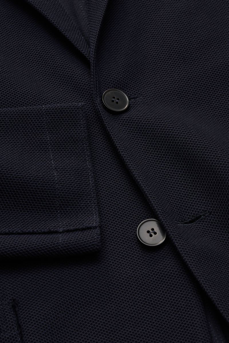 Close-up front view of Harris Wharf London Blazer navy showing two black buttons, patch hip pocket, step lapel, and fine waffle texture fabric. Lightweight blazer from HARRIS WHARF: This model with a fine but distinctive waffle texture is made of fine 