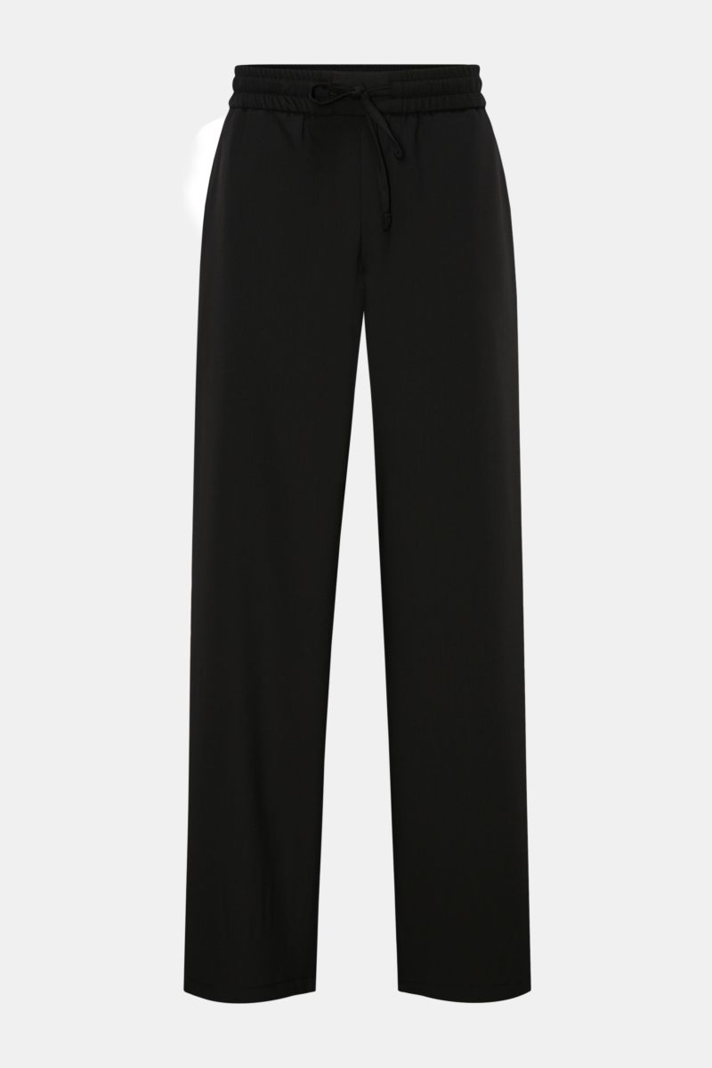 Ami Paris Jogger pants black shown from the front on a plain background, featuring a high waist, elasticated waistband with drawstring, zip and waist button, French pockets, patch back pockets, slight taper, loose fit in pure virgin wool. Trendy oversized
