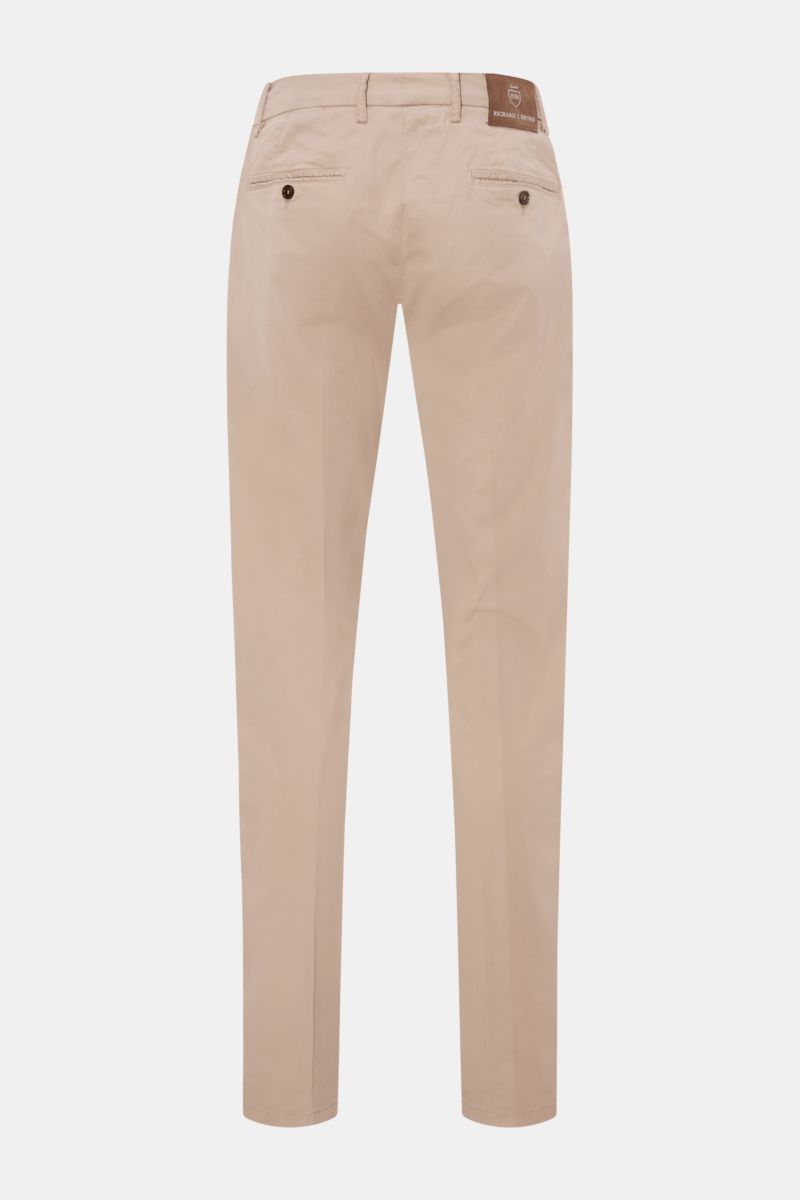 Richard J. Brown Chinos 'Singapore' beige shown from the back on a white background, slim fit tapered cotton twill pants with French pockets, small watch pocket, buttoned back pockets, zip and waist buttons, extended buttoned tab, and leather patch on the