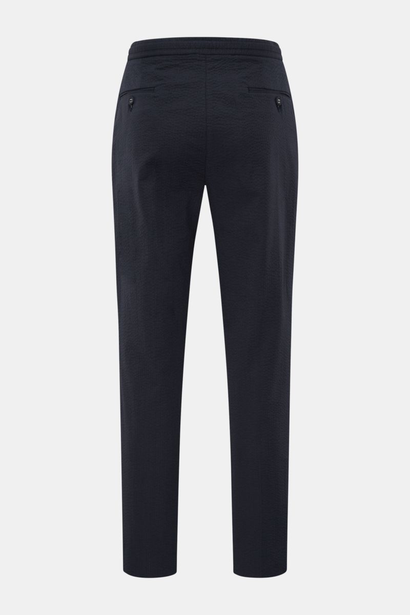 Rear view of Officine Générale Jogger pants 'Drew' navy in pure cotton seersucker, tapered fit with elastic waistband, zip and hook fastener, side seam pockets, single pleat, and jetted back pockets with button.