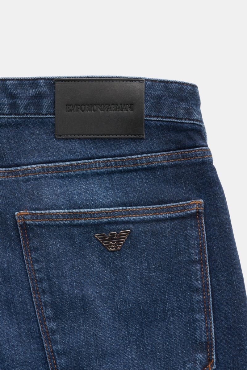 Close-up rear view of Emporio Armani Jeans dark blue showing the back pocket with metal logo and leather patch on waistband.

Comfort meets style: These jeans by EMPORIO ARMANI have a comfortable feel and a timeless aesthetic for modern casual looks.