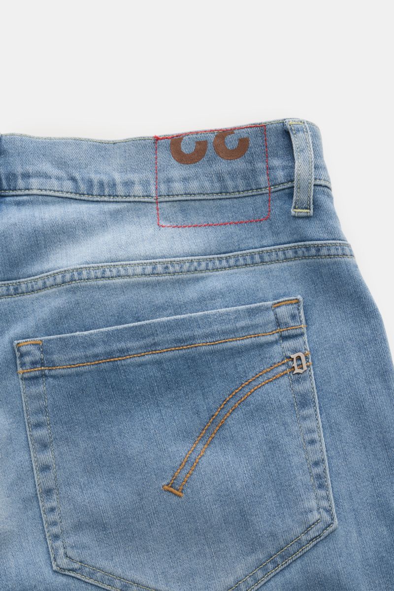 Close-up rear view of Dondup Jeans 'George' rauchblau in comfortable elastic cotton denim with soft touch, authentic used wash, skinny fit, narrow calf, low waist, button fly, five-pocket style, piped coin pocket, stitched back pockets, metal initial, and