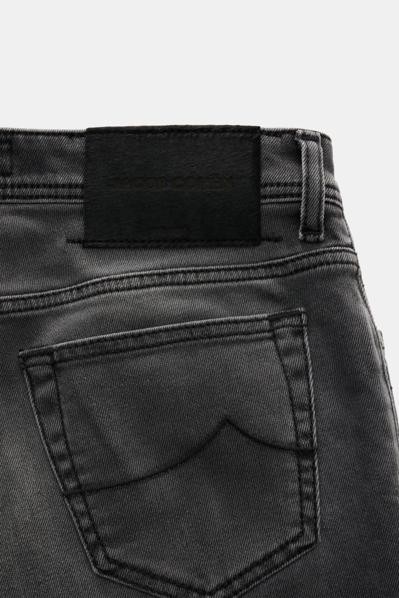 Jacob Cohen Jeans 'Bard' grau seen from the back showing the back pocket with stitching and a black leather patch in pony hair look. Denim aus Baumwolle und Microfaser, elastische Qualität, weicher Griff, dezente Used-Waschung, Slim Fit, schmal zulaufend,