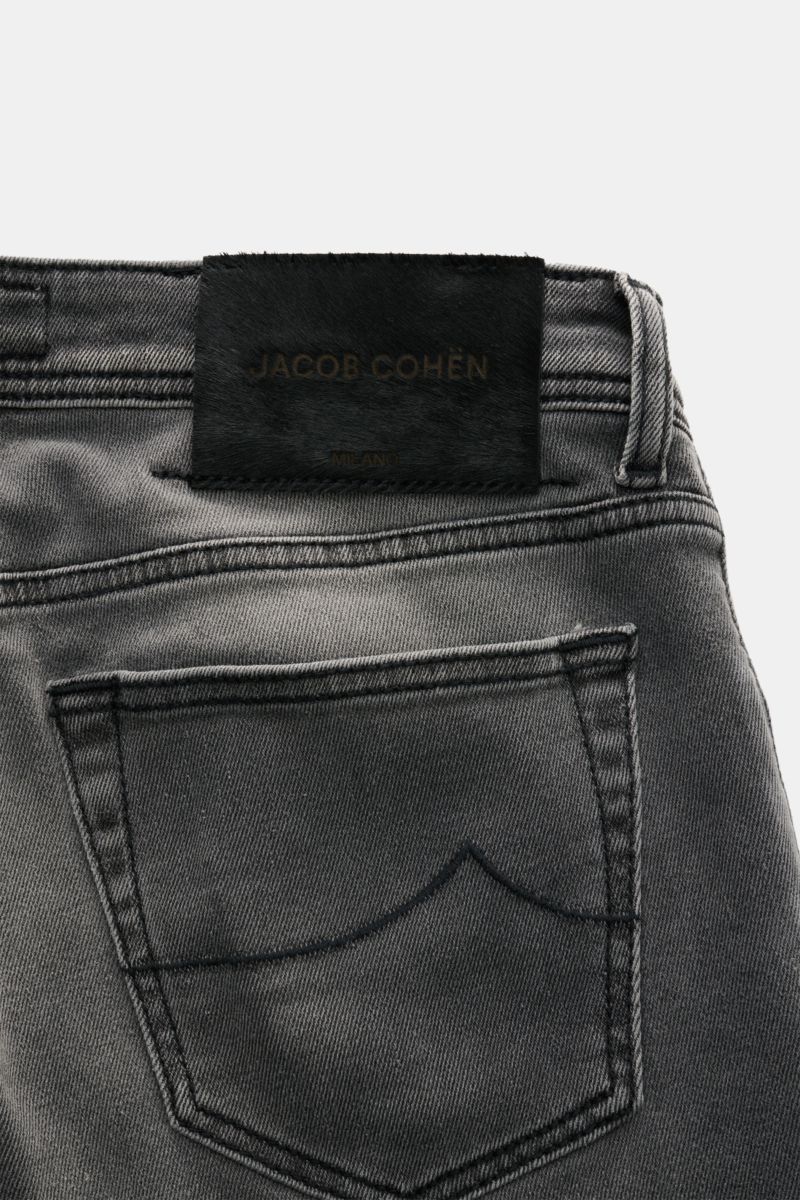 Close-up rear view of Jacob Cohen Jeans 'Nick' grey, showcasing subtle used wash, back pocket with stitching, leather patch in pony skin look. Denim made of cotton and microfibre, elasticated fabric, soft feel, slim fit, tapered cut, button fly, five-pock