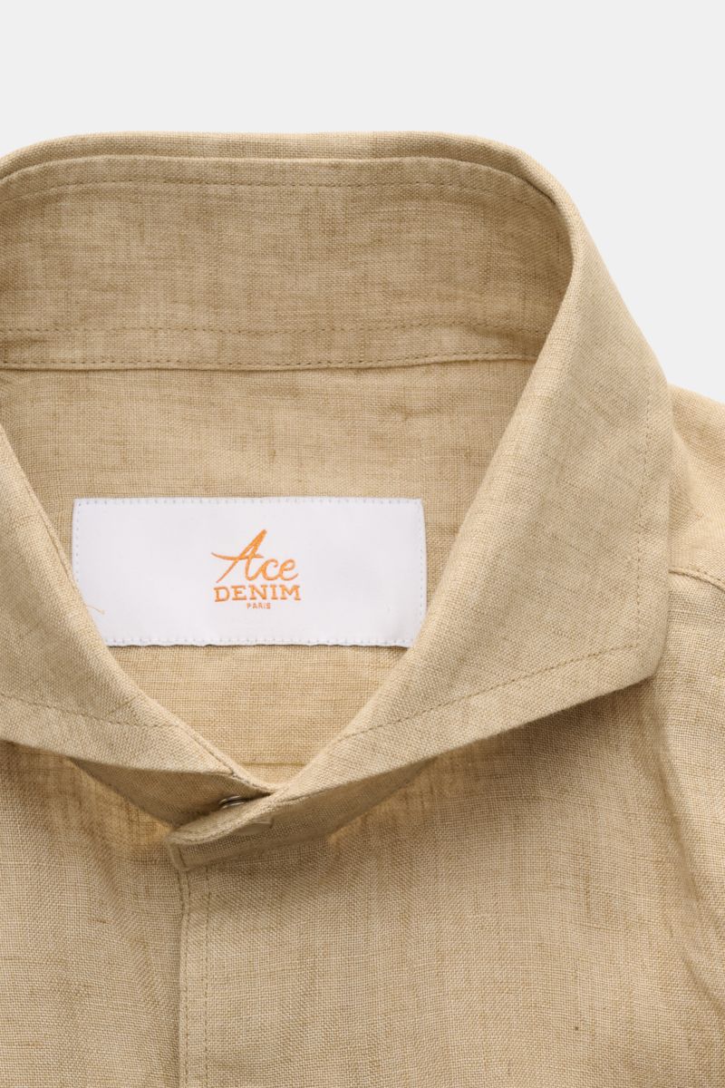 Close-up front view of Ace Denim Linen shirt shark collar beige showcasing its pure linen, lightweight fabric, shark collar, and French button placket with snap buttons. 

Stay comfortable in the warmer months: This ACE DENIM shirt in lightweight linen