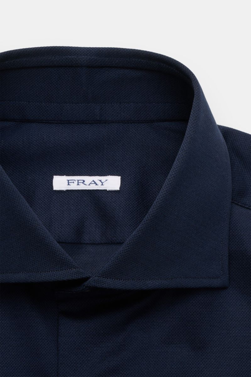 Close-up front view of the Fray Piqué-Hemd Haifisch-Kragen 'Lione Cucitura' navy shirt collar made of breathable pure cotton piqué fabric.

FRAY überzeugt mit dem Hemd 'Lione Cucitura' aus luftigem Piqué, gefertigt aus reiner Baumwolle – ein zeitloses 