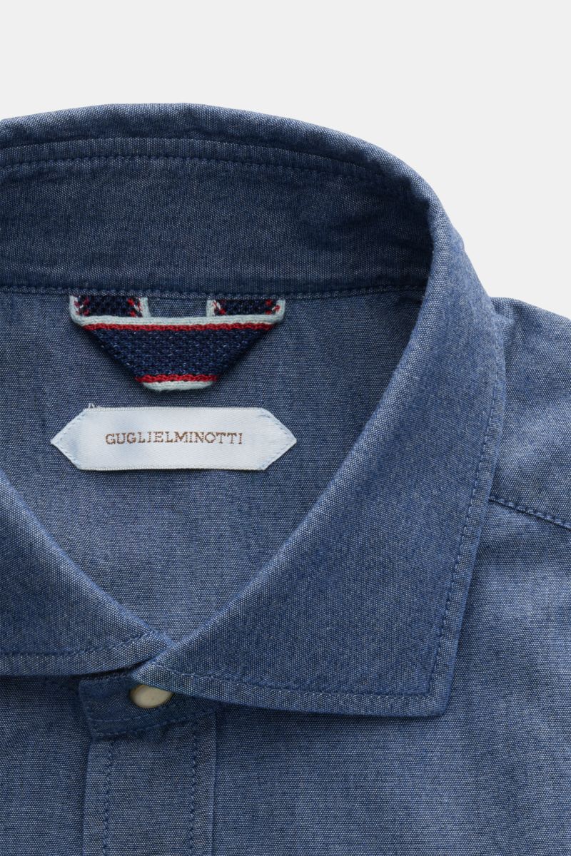 Guglielminotti Chambray shirt shark collar dark blue shown from a close-up front top view, pure cotton with smooth feel, handcrafted details, patch button placket, classic barrel cuffs, and slightly rounded hem.