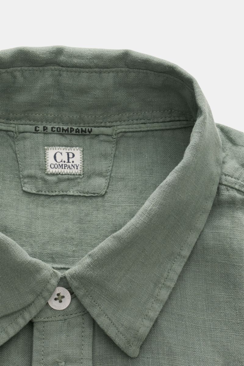 Close-up front view of C.P. Company Linen shirt slim collar sage in pure linen, garment-dyed soft fabric with narrow collar and button detail.

