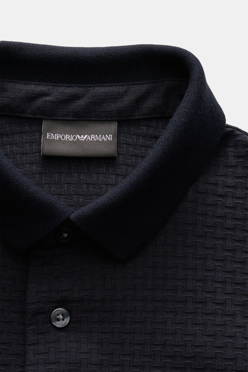 Close-up front view of the Emporio Armani Poloshirt navy showing the textured cotton jersey fabric, slim fit, typical polo collar, three-button placket, and straight hem. Purer Luxus von GIORGIO ARMANI: Dieses speziell getrickte Jersey-Poloshirt bestic