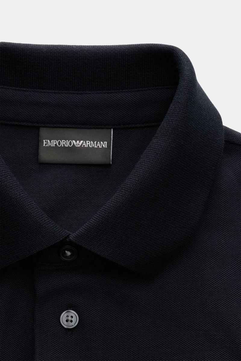 Close-up front view of the Emporio Armani Polo shirt navy showing the classic collar, two buttons, and label stitching on the chest. A versatile classic for sporty looks: This polo shirt by EMPORIO ARMANI has a timeless, casual design. Piqué jersey made o