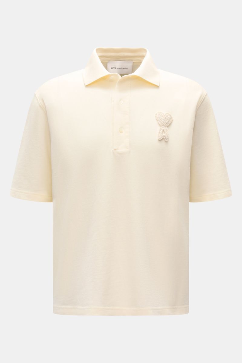 Front view of Ami Paris Polo shirt cream, a casual classic piqué cotton polo with three-button placket, oversized fit, and 3D ‘A’ logo stitching on chest. 

A casual classic among polo shirts: This piqué model in pure cotton with three-dimensional ‘A’ 