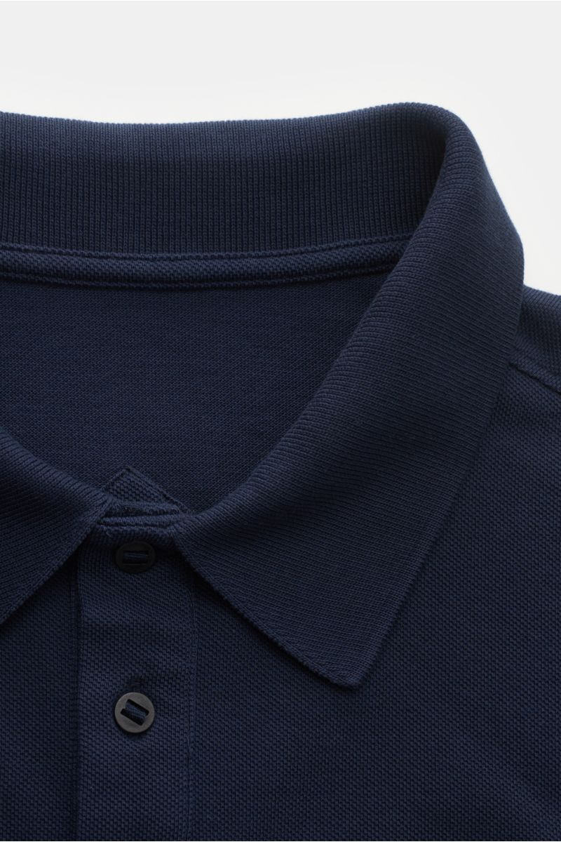 Close-up front view of the navy Canada Goose Poloshirt 'Beckley' showing the textured cotton piqué fabric, typical polo collar, three-button placket, and detailed stitching. Das klassische Poloshirt 'Beckley' ist ein Must