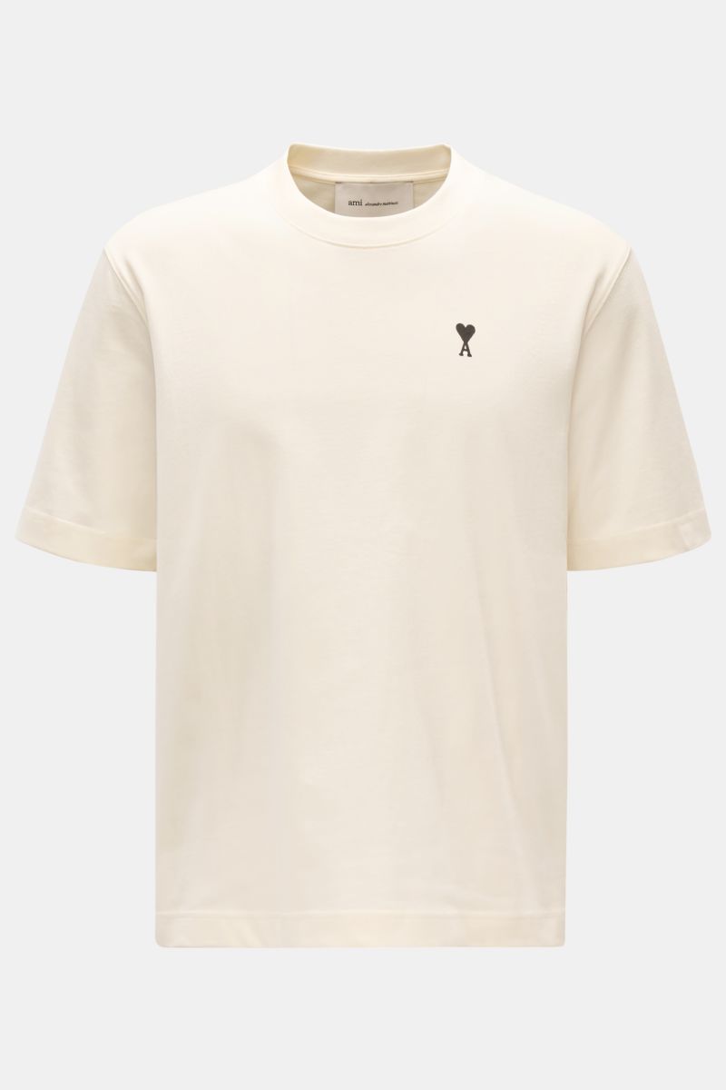 Ami Paris Rundhals-T-Shirt creme shown from the front, made of soft organic cotton jersey with a tonal stitched heart logo on chest. 

Monochromes Jersey-Basic vom französischen Label AMI PARIS: Dieses T-Shirt mit Rundhalsausschnitt ist aus reiner Bio-