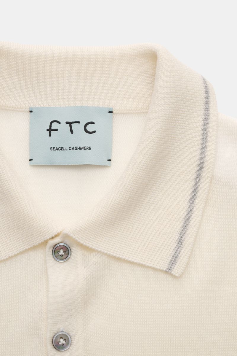 FTC Short sleeve knit polo cream shown from a close-up front perspective, featuring a classic collar, three-button placket, and narrow contrasting borders. Sustainable from fibres to finished model: This short sleeve knit polo in the finest cashmere-SeaCe