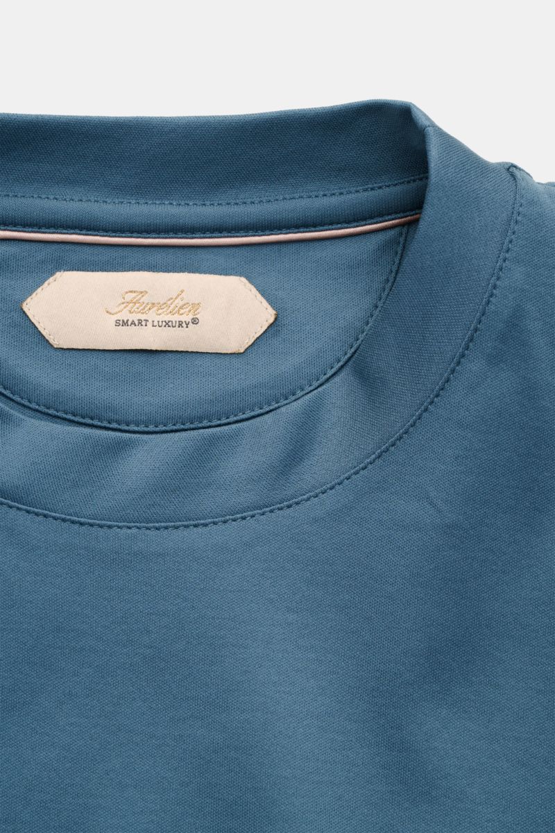 Close-up front view of the Aurélien Rundhals-T-Shirt petrol showing the round neckline, soft cotton fabric, tonal logo stitching, and label tag. Versatile basic for spring and summer: The Aurélien Rundhals-T-Shirt petrol combines pure cotton, a soft touch