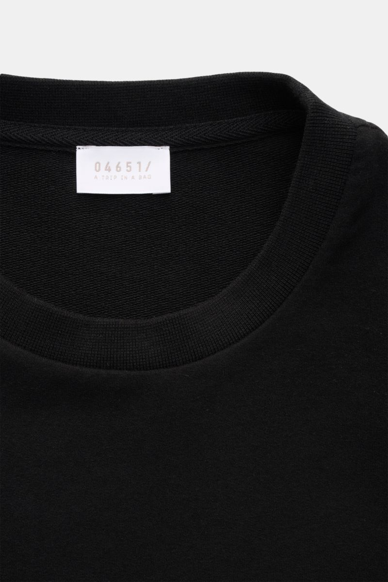Close-up front view of 04651/ A trip in a bag Crew neck T-shirt 'If Tee' black showing ribbed crew neck and white label.

The uncomplicated cotton T-shirt 'IF Tee' by 04651/ A TRIP IN A BAG is a core basic for the new season that give us a taste of a r