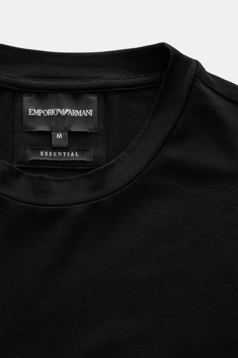 Close-up front top view of Emporio Armani Crew neck T-shirt black showing crew neck and brand label inside collar.

This clean T-shirt with crew neck by EMPORIO ARMANI benefits from a purist design, high-quality finish and the comfortable properties of