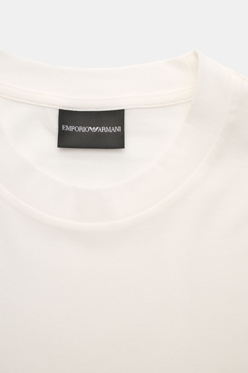 Close-up top-front view of Emporio Armani Crew neck T-shirt off-white featuring a classic crew neck and visible label.

This T-shirt by EMPORIO ARMANI combines a purist design and the comfortable feel of a high-quality lyocell-cotton blend. The classic