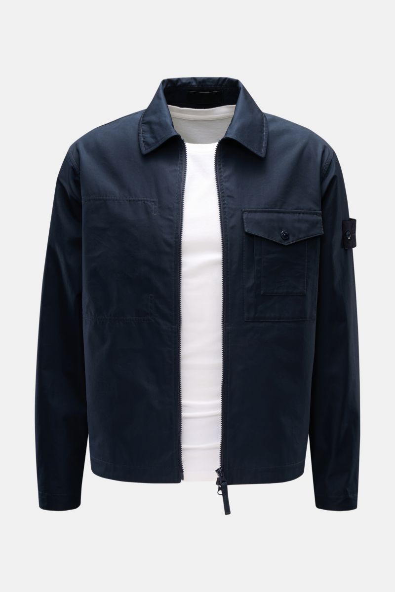 Front view of Stone Island Overshirt 'Ghost Piece' navy in dense woven pure cotton canvas, slim fit, with wind- and water-repellent fabric, robust two-way zipper, turn-down collar, buttoned chest flap pocket, tonal badge on upper arm, and buttoned sleeve 