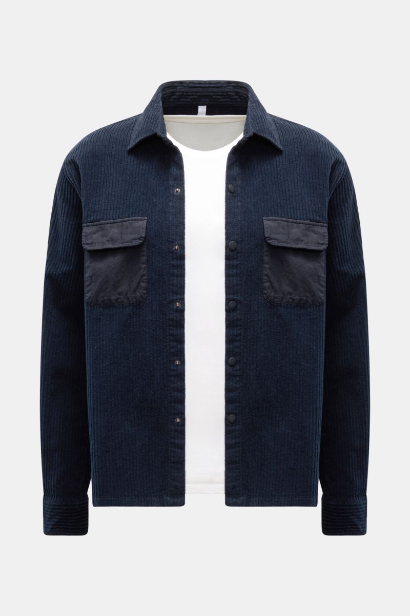 Front view of the 04651/ A trip in a bag Cord-Overshirt navy, oversized with Kent collar, Breitcord cotton, stretch, soft feel, garment dyed, snap button placket, contrast chest pockets, snap cuffs, and straight hem.