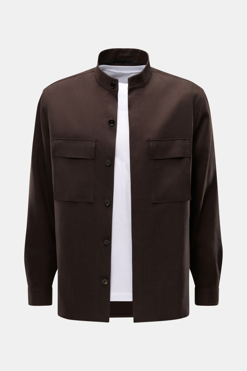 Zegna Linen overshirt dark brown shown from the front, featuring a grandad collar, concealed six-button placket, patch breast pockets with flap, cuffs with button, slanted hip pockets, short hem vents, and one inside pocket. 

Minimalism from ZEGNA: Th