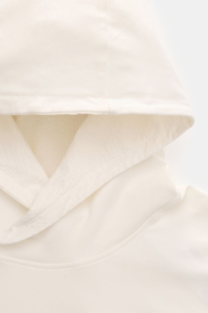 Close-up front view of the hood and upper chest of the 04651/ A trip in a bag Kapuzenpullover 'IF Hoodie' offwhite, made of brushed elastic cotton jersey with a very soft feel, featuring a regular fit, practical hood, small side seam web label, and comfor