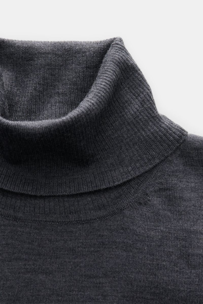 Close-up top-down view of 04651/ A trip in a bag Merino Rollkragenpullover grau meliert, a slim fit gray turtleneck sweater in fine Merino wool with soft touch, ribbed collar, fine knit, and short hem slits. 

Description: Zeitloser Komfort für coole L