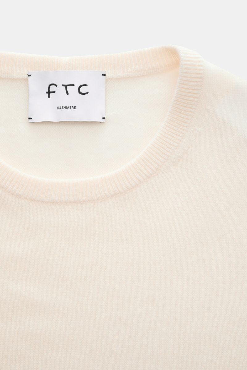 Close-up top-down view of FTC Cashmere crew neck jumper cream showing fine knit, slim fit, ribbed crew neck, and label.

The feel of ultra soft cashmere fabric makes this timeless crew neck jumper by sustainable knitwear label FTC CASHMERE a knitted fa