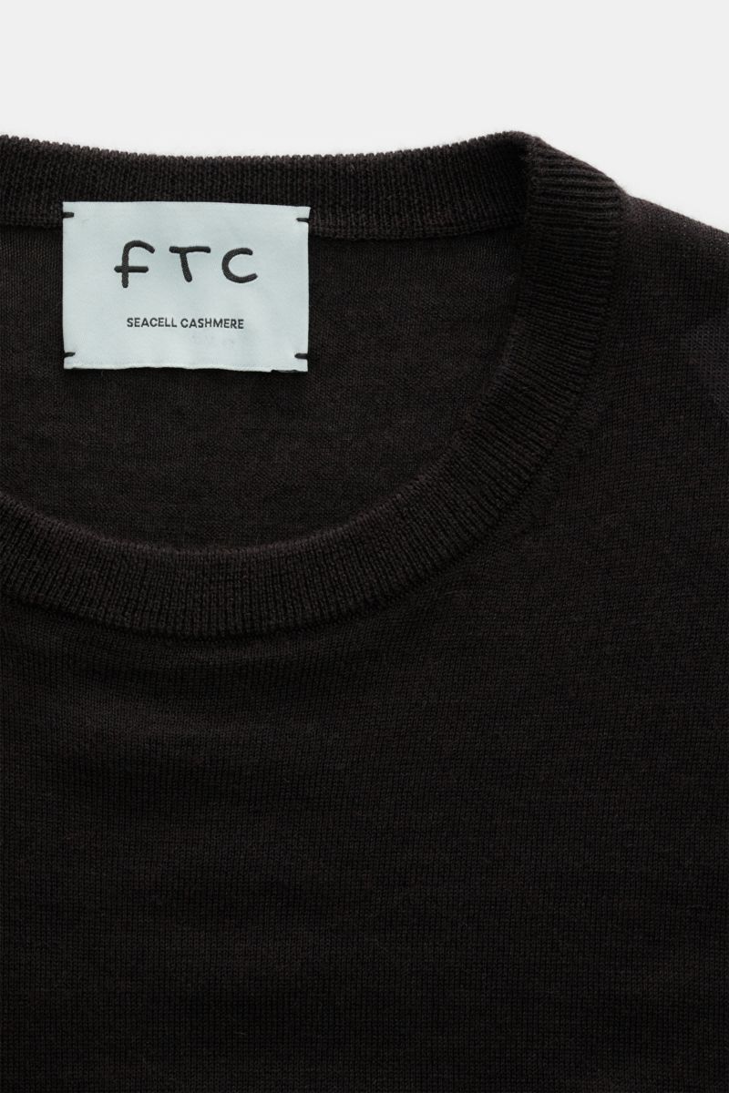 Close-up top view of the FTC Fine knit crew neck jumper dark brown, showing crew neck, slim fit, very fine knit, comfortable ribbed bands, blend of cashmere and lyocell, OEKO-TEX® Standard 100 certified, very soft feel.