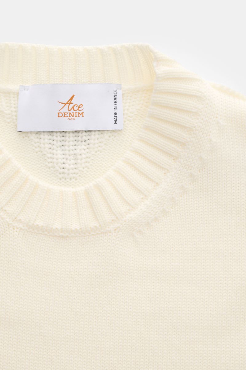 Close-up front view of Ace Denim Merino crew neck jumper cream showing ribbed crew neck collar and Ace Denim label, made of pure merino wool with a soft, semi chunky knit, slim fit, and wide ribbed bands. 