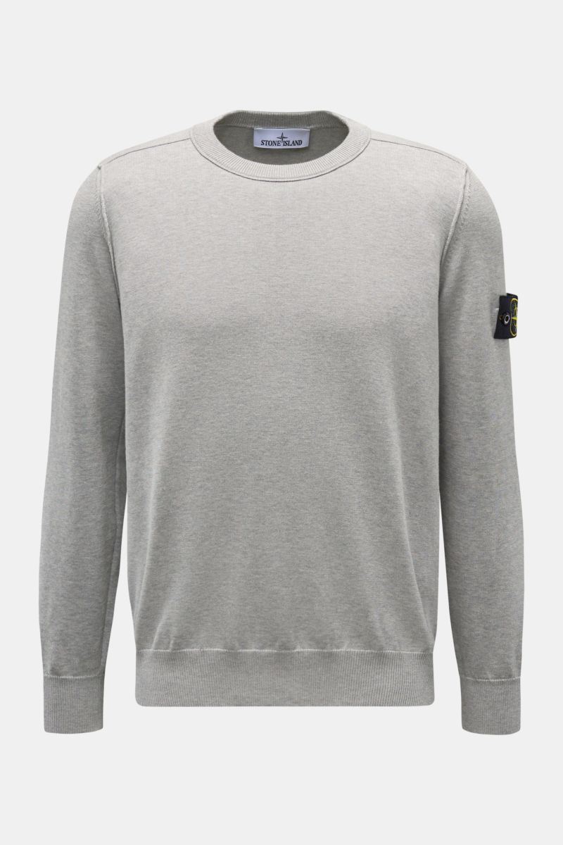 Stone Island Crew neck jumper light grey mottled shown from the front, knitted from pure cotton with soft feel, fine knit, slim fit, outer seams, signature compass badge on the upper sleeve, and elasticated ribbed bands. 

Timeless classic: This knitte