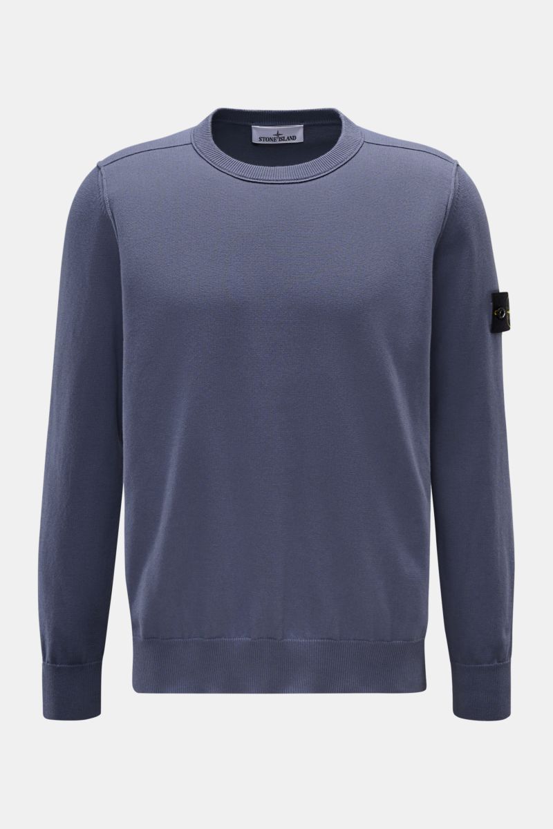 Front view of Stone Island Crew neck jumper smoky blue, knitted from pure cotton with soft feel, fine knit, slim fit, outer seams, elasticated ribbed bands, and signature compass badge on upper sleeve.

Timeless classic: This knitted jumper by STONE IS