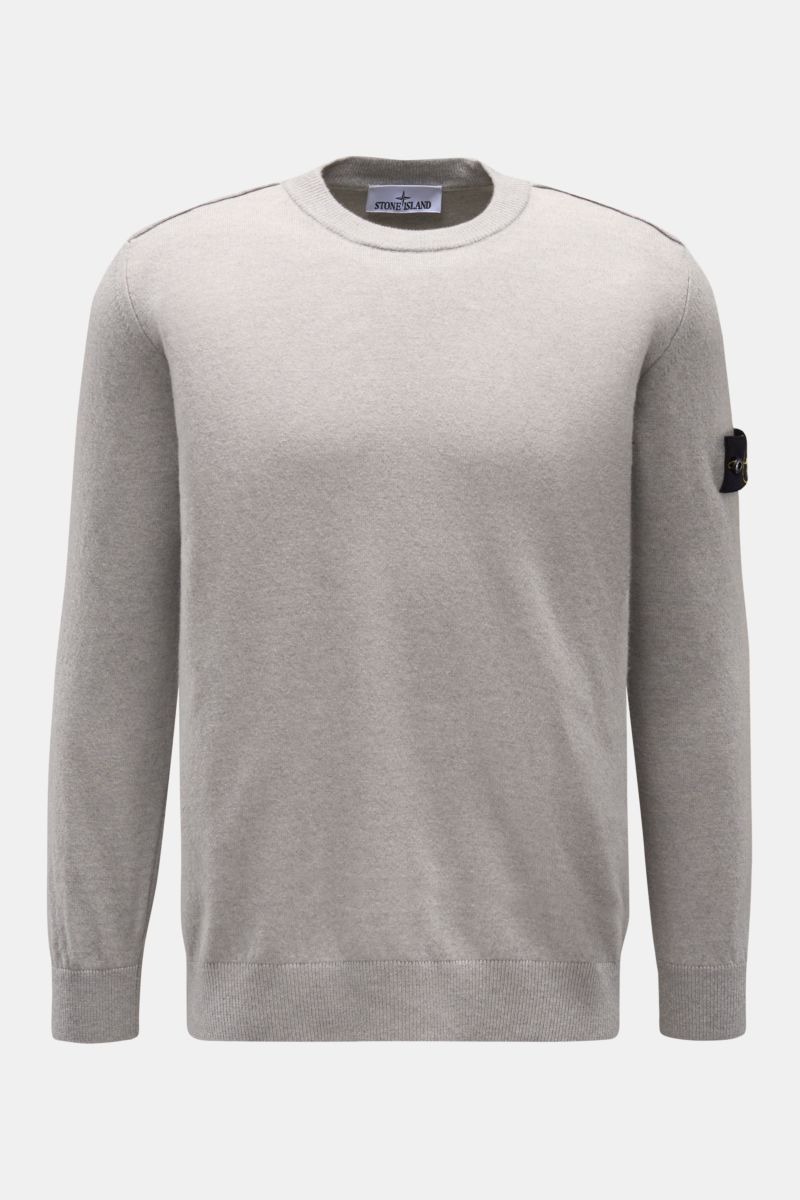 Stone Island Crew neck jumper grey shown from the front on a plain background, featuring pure wool knit, soft feel, fine knit, regular fit, crew neck, tonal compass badge on the upper sleeve, and elasticated ribbed bands. 

A timeless piece from STONE 