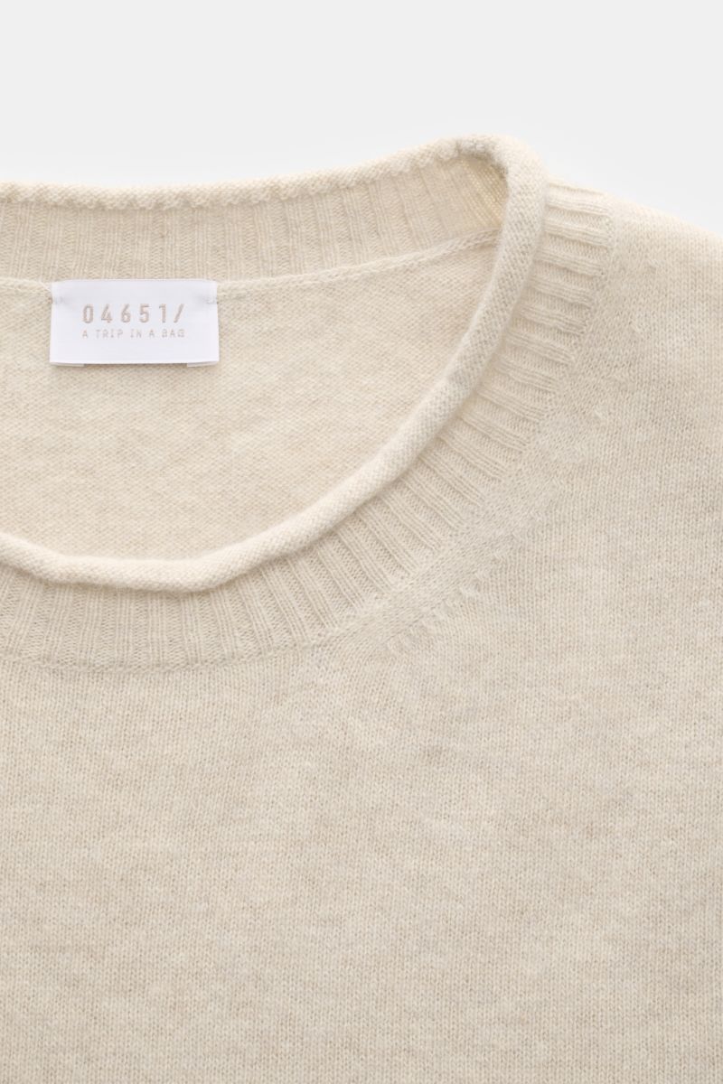Close-up top-down view of the sand-colored 04651/ A trip in a bag Crew neck jumper 'Boiled Crew' showing the fine knit fabric and ribbed crew neck. Stylish comfort for cold days: This crew neck jumper by 04651/ A TRIP IN A BAG is a versatile piece with ti