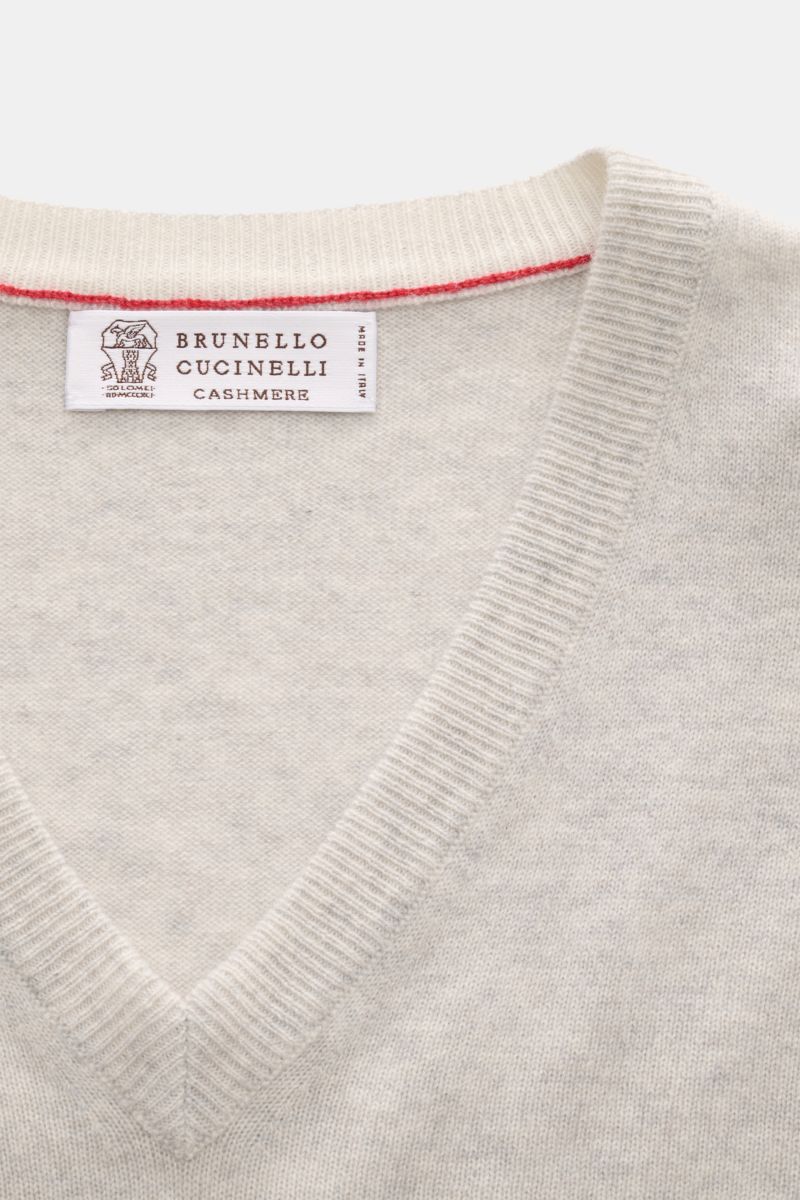 Close-up top-down view of the Brunello Cucinelli Cashmere V-Neck Pullover hellgrau meliert showing its fine knit, soft texture, V-neck, and slim contrast edges. Luxuriöser Cashmere in Verbindung mit klassischem Design: Der V-Neck Pullover mit schmalen Kon