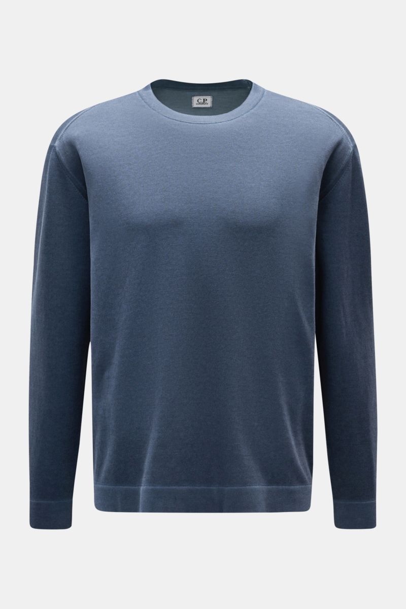 Front view of a C.P. Company Crew neck jumper navy in pure cotton with a distinctive garment-dyed design, fine knit, regular fit, soft feel, crew neck, ribbed bands, and logo print on sleeve hem. With its distinctive garment-dyed design, this crew neck