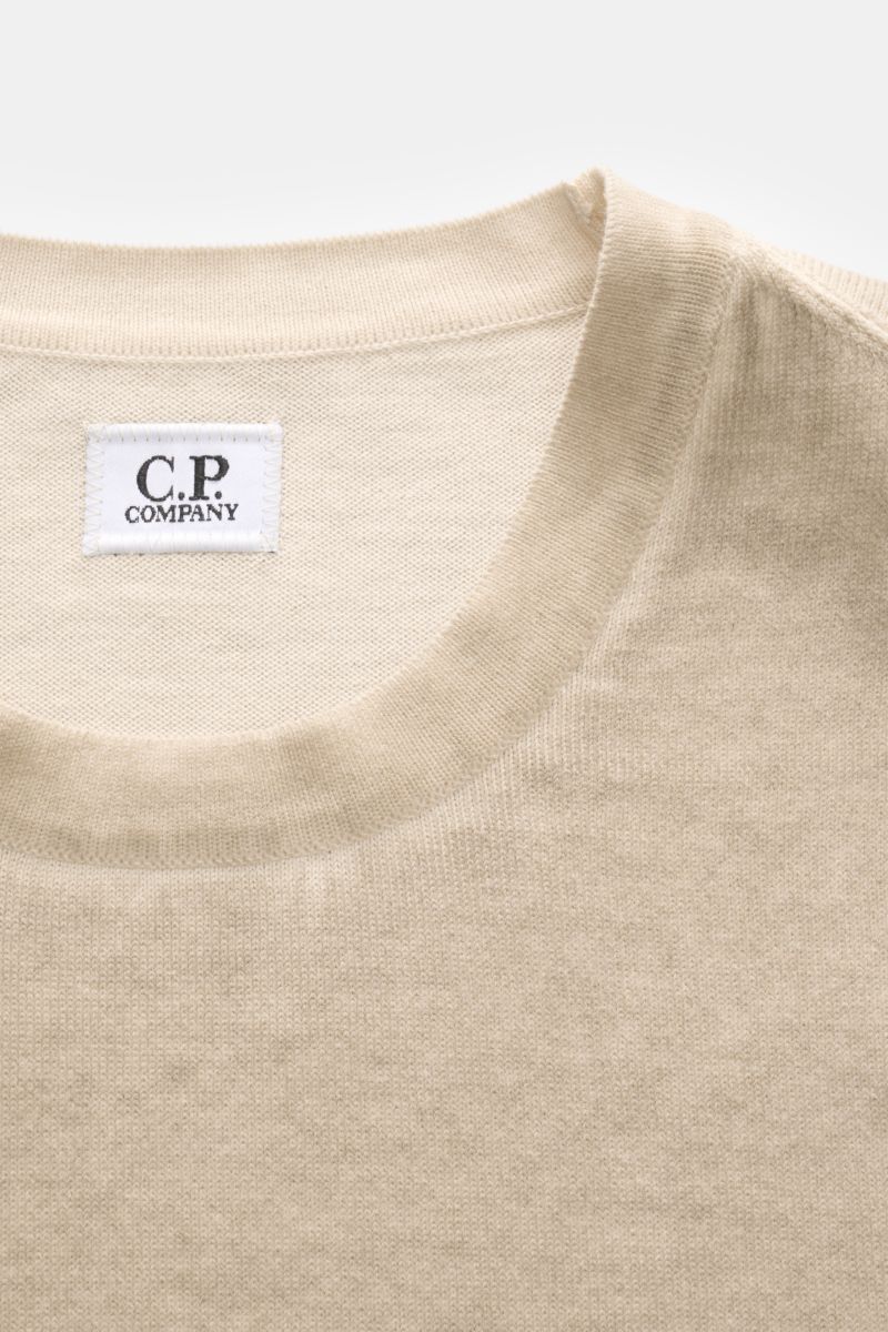 Close-up front view of C.P. Company Crew neck jumper beige showing fine knit crew neck and label inside collar.

With its distinctive garment-dyed design, this crew neck jumper in pure cotton by C.P. COMPANY enhances contemporary casual wardrobes. 