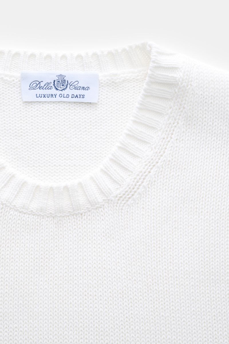Close-up front view of the white Della Ciana Crew neck jumper showing ribbed crew neckline and label.

This elegant Italian cotton jumper by DELLA CIANA will enhance your spring wardrobe with its classic fit and can be styled in a variety of ways to cr