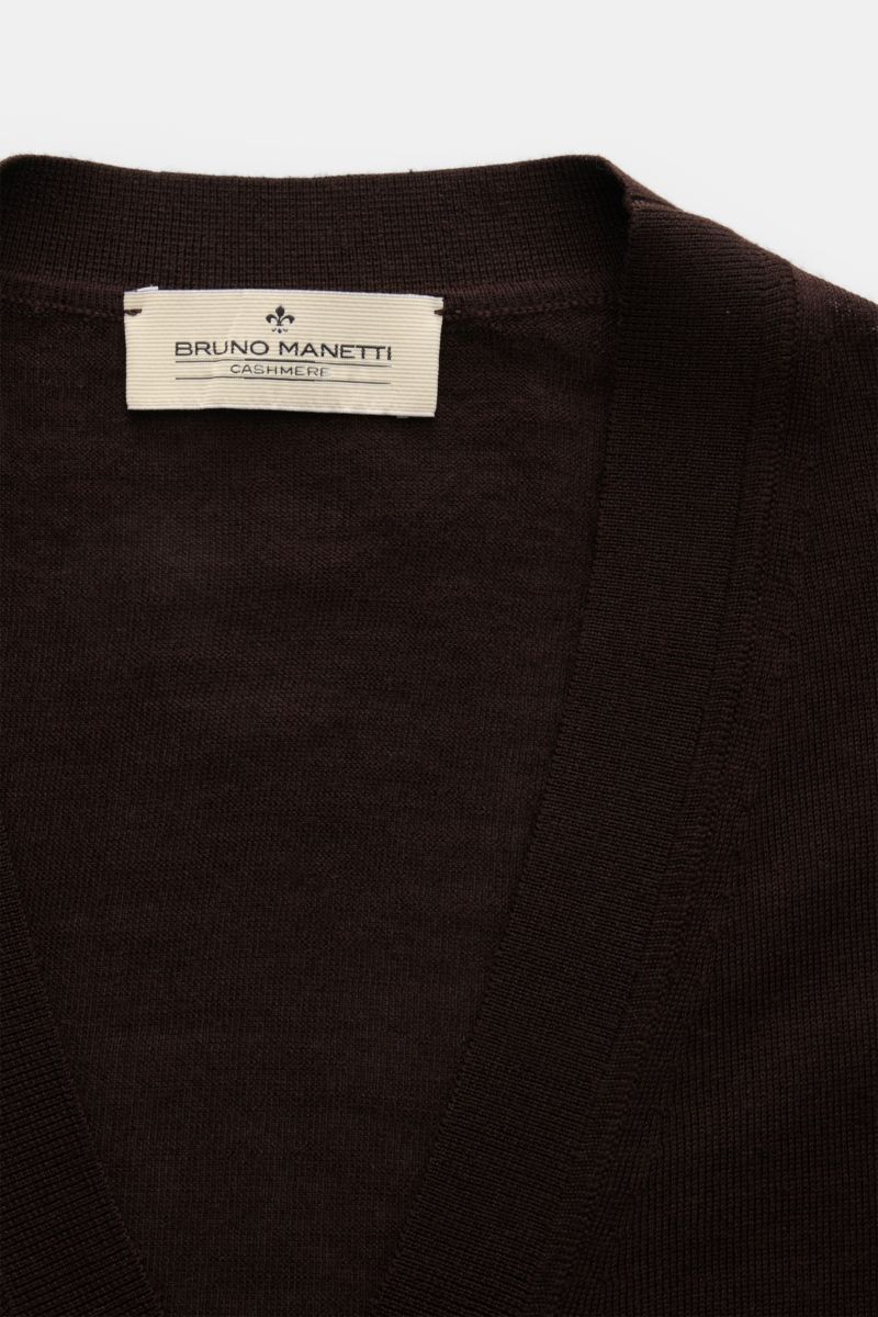 Close-up front view of the dark brown Bruno Manetti Cashmere silk cardigan showing its fine knit, V-neck, and label. Luxury you can feel on your skin: this fine knit cardigan by BRUNO MANETTI has an exceptionally soft feel and timeless elegance. The luxur