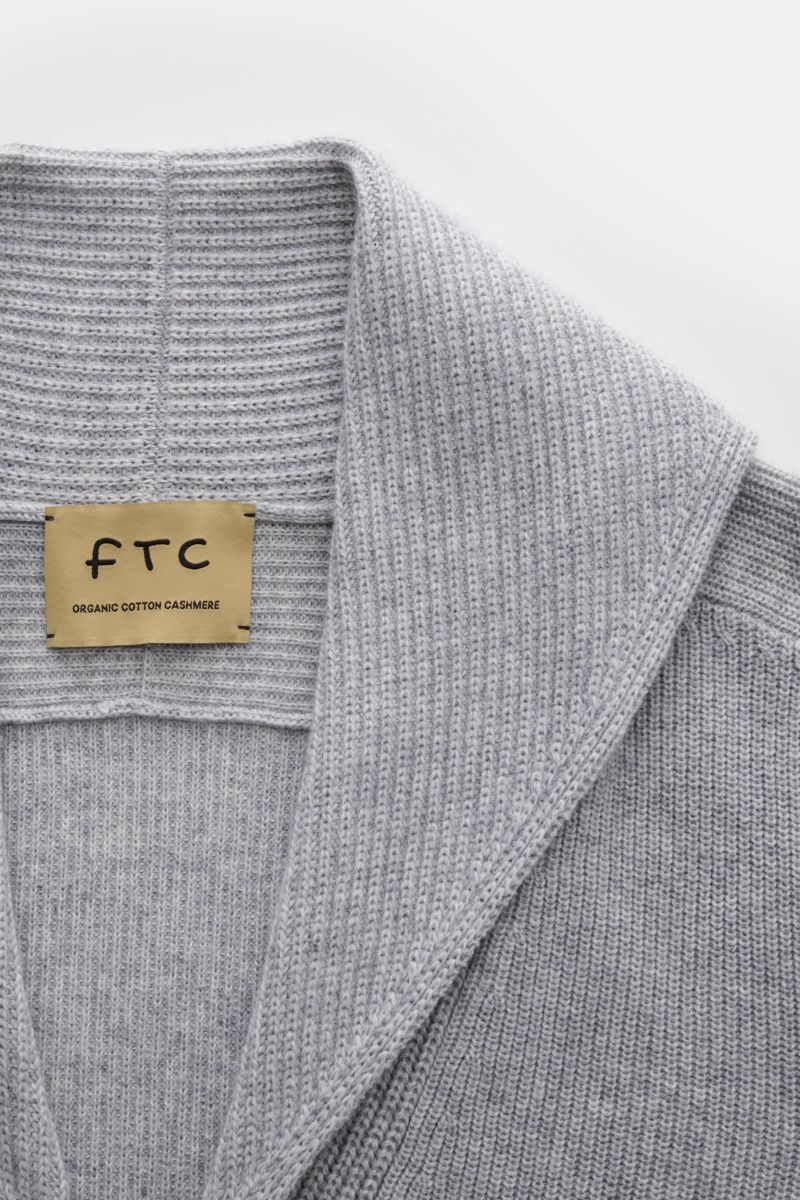 Close-up front view of the FTC Cardigan grey showing the shawl collar and ribbed knit texture.

This luxurious cardigan from sustainable knitwear label FTC is a classic knitted essential made from cotton and fair trade cashmere – and a must-have in any