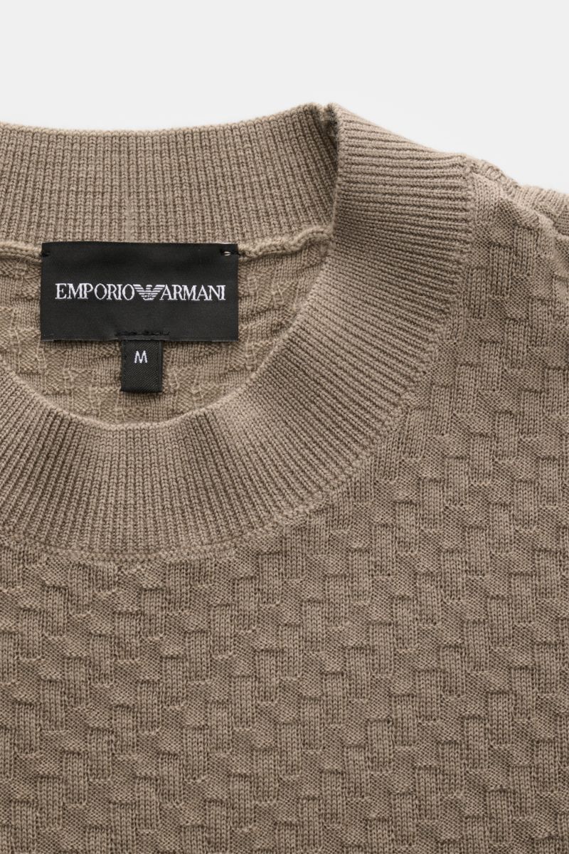 Emporio Armani Crew neck jumper beige shown from a top close-up view, highlighting the textured knit and ribbed bands. Versatile companion: This lightweight short sleeve jumper in pure virgin wool by EMPORIO ARMANI has a subtle textured pattern and is 