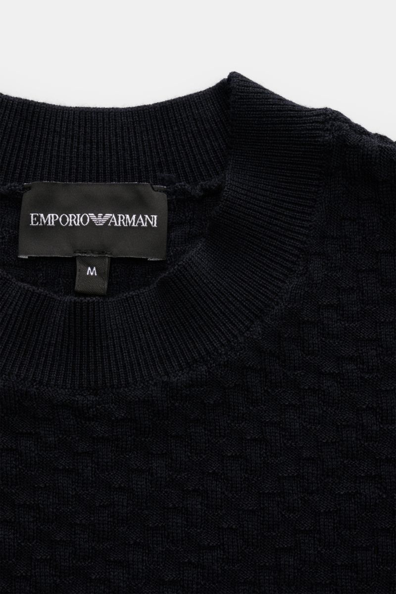 Close-up front top view of Emporio Armani Short sleeve jumper navy showing ribbed crew neck and textured fine knit pattern.

Versatile companion: This lightweight short sleeve jumper in pure virgin wool by EMPORIO ARMANI has a subtle textured pattern a