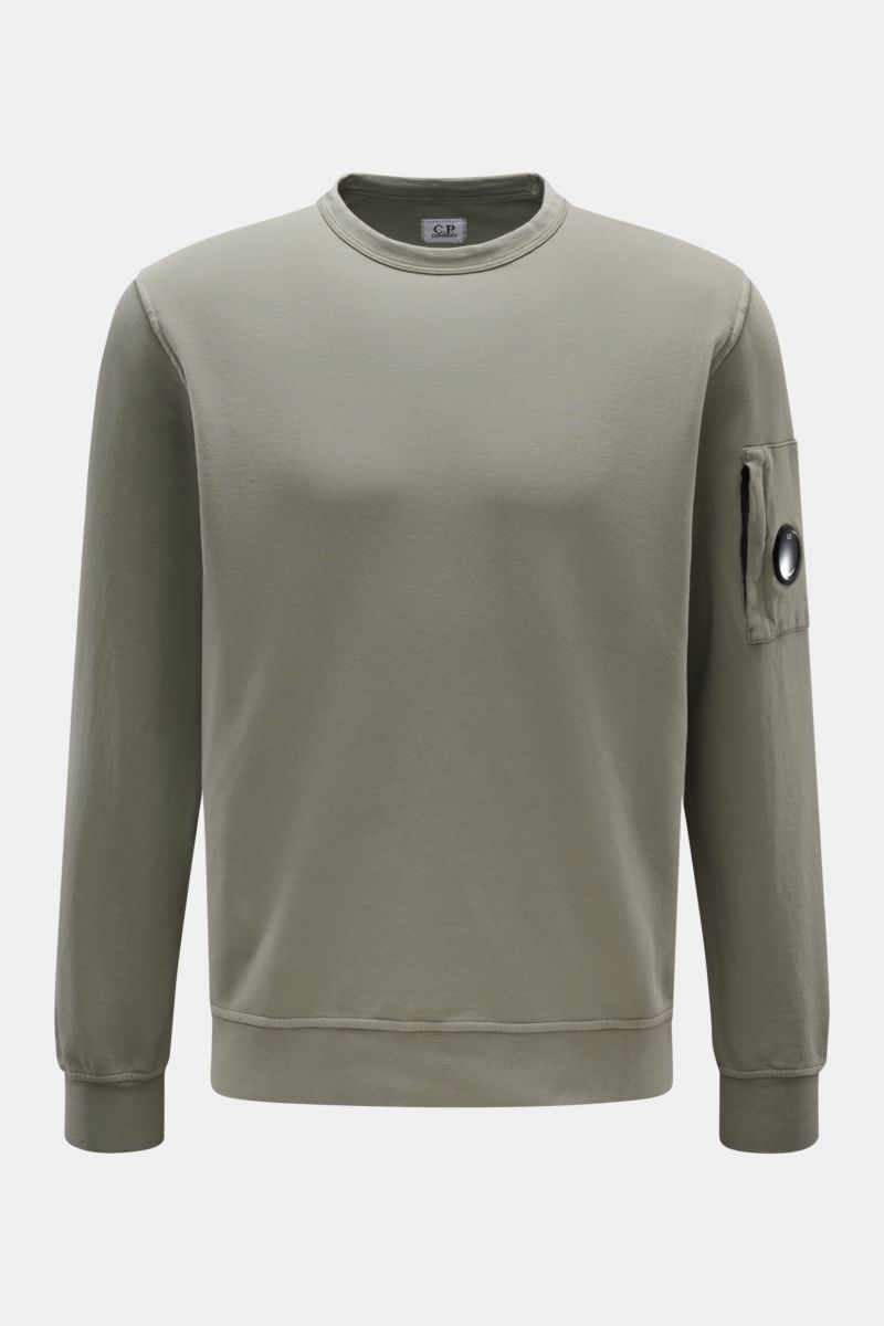 Front view of a C.P. Company Sweatshirt salbei in a slim fit, light garment-dyed pure cotton with a round neckline, ribbed cuffs, and a zipped sleeve pocket featuring the brand's signature lens detail. 