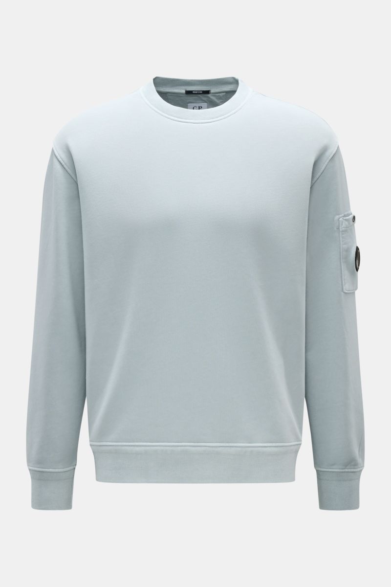 C.P. Company Sweatshirt smoky blue, front view of a lightweight pure cotton crew neck with regular fit, sleeve pocket, and signature lens detail.